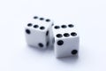 Two white dice with black dots on a white background. Royalty Free Stock Photo