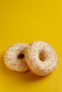 Two white donuts on yellow background top view copy space Royalty Free Stock Photo