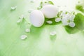 Two white eggs with Apple blossom and green leaves on wooden background. Easter Royalty Free Stock Photo