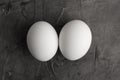 Two white eggs on a black background. Royalty Free Stock Photo
