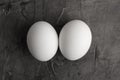 Two white eggs on a black background. Royalty Free Stock Photo