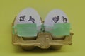 .two white eggs with green masks for fear of contagion of the coronavirus Royalty Free Stock Photo