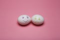 Two white eggs sad and cheerful drawn emoticon facial expression. Optimist and pessimist. On a pink background for Royalty Free Stock Photo