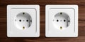 White electric power sockets isolated on wooden background. 3d illustration Royalty Free Stock Photo