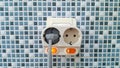 Two white electrical outlets on mosaic tiles wall Royalty Free Stock Photo