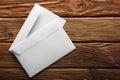 Two white envelopes with letters on old wooden dark background. Blanks for the designer. Concepts, ideas for postal services and e Royalty Free Stock Photo