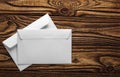 Two white envelopes with letters on old wooden dark background. Blanks for the designer. Concepts, ideas for postal services and e Royalty Free Stock Photo