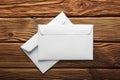 Two white envelopes with letters on old wooden dark background. Blanks for the designer. Concepts, ideas for postal services and e Royalty Free Stock Photo