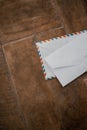 Two white envelopes on a wooden table Royalty Free Stock Photo