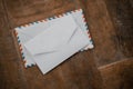 Two white envelopes on a wooden table Royalty Free Stock Photo