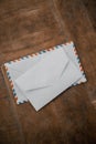 Two white envelopes on a wooden table Royalty Free Stock Photo