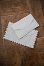 Two white envelopes on a wooden table Royalty Free Stock Photo