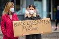 Two white female protesters hold a homemade Black Lives Matter placard at an anti-racism protest in Richmond, North Yorkshire