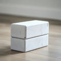 Two white foam yoga blocks are stacked on a wooden floor. The blocks are rectangular Royalty Free Stock Photo