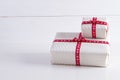 Two white gift boxes with polka dots a red ribbon. Royalty Free Stock Photo
