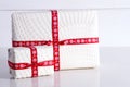 Two white gift boxes with polka dots a red ribbon. Royalty Free Stock Photo