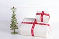 Two white gift boxes with polka dots a red ribbon. Royalty Free Stock Photo