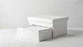 Two white gift boxes sit stacked. Clean boxes for presents or jewelry. Simple container mockup on light studio background. Royalty Free Stock Photo