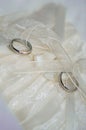 Two white gold wedding rings on white lace pad Royalty Free Stock Photo