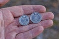 two white gray new Ukrainian coins lie on a brown palm on a hand