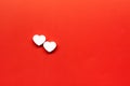 Two white heart pills on a red background with place for text