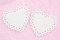 Two white hearts on pale pink plush lined fabric background
