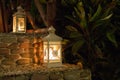 Two white lamps with burning flame on street steps. Lantern in the evening garden in Asia. Romantic decoration.