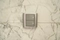 Two white lighting switchs on marble wall, two choices two ways for making decision concept Royalty Free Stock Photo