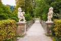 Two white marble dwarfs at the entrance to the Dwarf Garden Zwerglgarten playing Pallone game. Dwarf garden is a part of