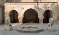 Two white marble lions statues and decorative fountain