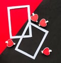 Two white mockup photo frames decorative with hearts on geometric black and red background. Minimal concept, copy space for the te Royalty Free Stock Photo
