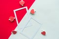 Two white mockup photo frames decorative with hearts on geometric white and red background. Royalty Free Stock Photo