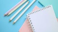 Two white notebooks with light blue, pink, and white colored pencils between on light blue backdrop. Ai Generated