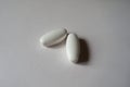 Two white oblong caplets of calcium citrate