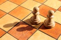 Two white pawns figures stands on a chess board Royalty Free Stock Photo