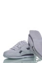 Two White Pieces of Footwear as Pair of New White Sneakers Placed Against White Background Royalty Free Stock Photo