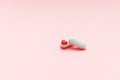 Two white pills on pink background with red heart shape, cardiac medications or femine cure Royalty Free Stock Photo