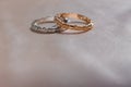 Two white and pink golden wedding rings on satin background, wedding rings concept Royalty Free Stock Photo