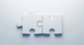 Two white puzzle pieces interlocked. Solution, cooperation, complementarity, and minimal concepts Royalty Free Stock Photo