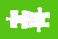 Two white puzzle pieces isolated on green background Royalty Free Stock Photo