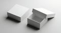 Two white rectangular boxes one closed and one open on a gray surface Royalty Free Stock Photo
