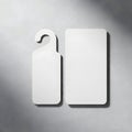 Two white rectangular objects with a hanging hook on a gray back Royalty Free Stock Photo