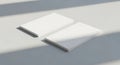 Two white rectangular objects on a light gray surface with shadow Royalty Free Stock Photo