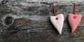 Two white and red material hearts on a dark wooden background Royalty Free Stock Photo