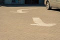 Two white road arrows. Textured grey asphalt Royalty Free Stock Photo