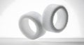 Two white rolls of hook and loop fasteners against a bright background Royalty Free Stock Photo