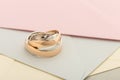 Two white and rose gold wedding rings on pastel background Royalty Free Stock Photo