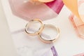 Two white and rose gold wedding rings on pastel background Royalty Free Stock Photo