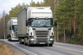 Two White Scania R420 Semi Trailer Trucks on the Road