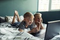 Two white schoolboy boys enjoy and study with a laptop Royalty Free Stock Photo